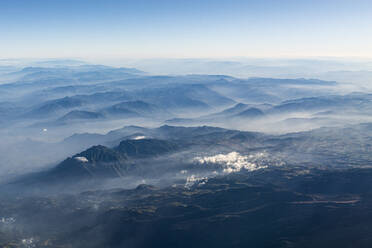 Aerial view of mountains shrouded in fog - RUNF04597