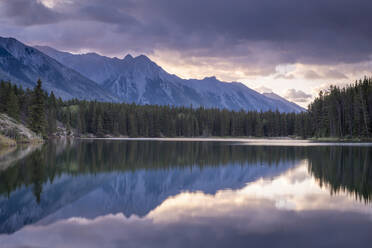 Sunrise over the mountains of the Rockies, reflected in Johnson Lake, Banff National Park, UNESCO World Heritage Site, Alberta, Canada, North America - RHPLF19972