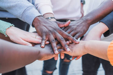 Crop unrecognizable multiethnic social justice warriors joining hands while supporting each other in BLM movement - ADSF26079