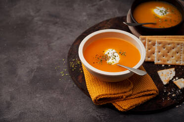 Delicious plates of creamy pumpkin soup seen from above - ADSF26211