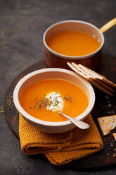 Delicious plates of creamy pumpkin soup seen from above - ADSF26212