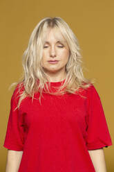 Portrait serene blonde woman meditating with eyes closed - FSIF05727