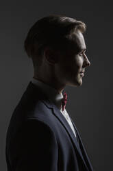 Profile portrait handsome young man in suit with bow tie - FSIF05728