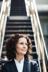 Thoughtful businesswoman looking away in industry - MOEF03773