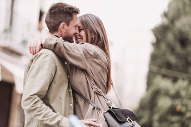 Woman smiling while embracing boyfriend - LJF02270