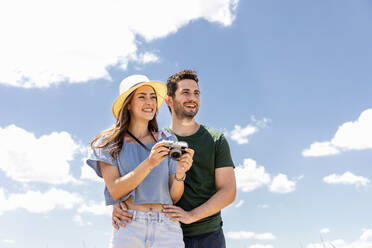 Happy couple with camera on sunny day - EIF01629