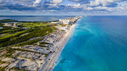 Mexico, Quintana Roo, Cancun, Aerial view of coastal city surrounded by blue waters of Caribbean Sea - RUNF04632