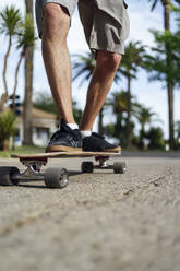 Man with skateboarding on road - PGF00670