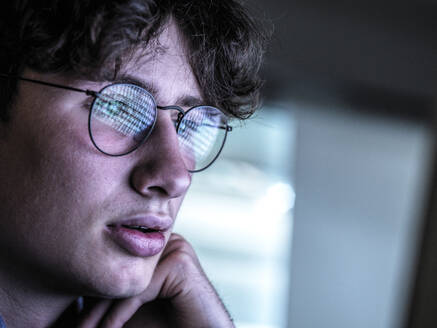 Worried teenage boy with reflection on eyeglasses - ABRF00904