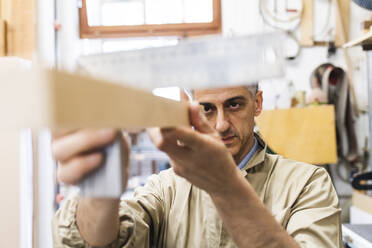 Mature man working at workshop - MEUF03581