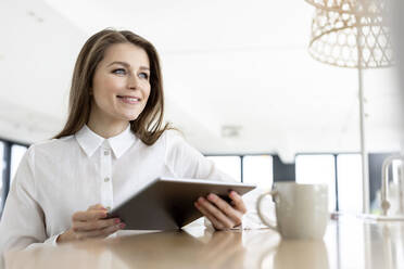 Thoughtful female professional with digital tablet at office - PESF02961