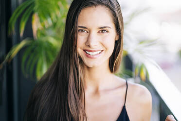 Smiling young woman with long hair - OCMF02194