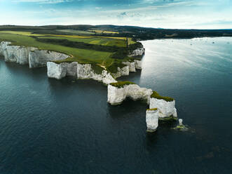 Aerial view of the iconic landmark of Old Harry Rocks and its white cliffs made of chalk in Studland, Dorset, United Kingdom. - AAEF09741