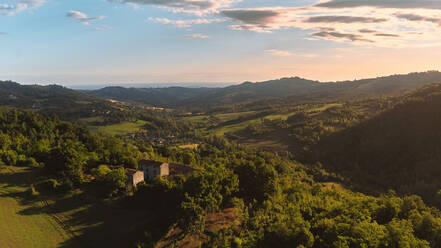 Luftaufnahme einer idyllischen ländlichen Landschaft der Colli Piacentini im Sommer bei Sonnenaufgang in der Nähe von Rossoreggio, Emilia-Romagna, Italien. - AAEF09756