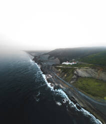 Aerial view of a beautiful coastline with waves breaking on the shore facing the Atlantic Ocean near Coimbra, Portugal. - AAEF09770