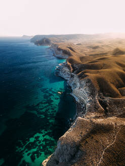 Aerial view of beautiful coastline with cliffs and turquoise water near Almeria, Andalusia region, Spain. - AAEF09793