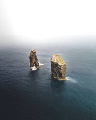 Aerial view of Ilheus dos Mosteiros, a rock formation in the middle of the ocean, in Azores archipelagos, Portugal. - AAEF09816
