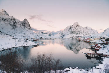 From above houses of town near high hill on coast of lake in winter in Arctic Island - ADSF27522