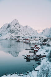 From above houses of town near high hill on coast of lake in winter in Arctic Island - ADSF27523