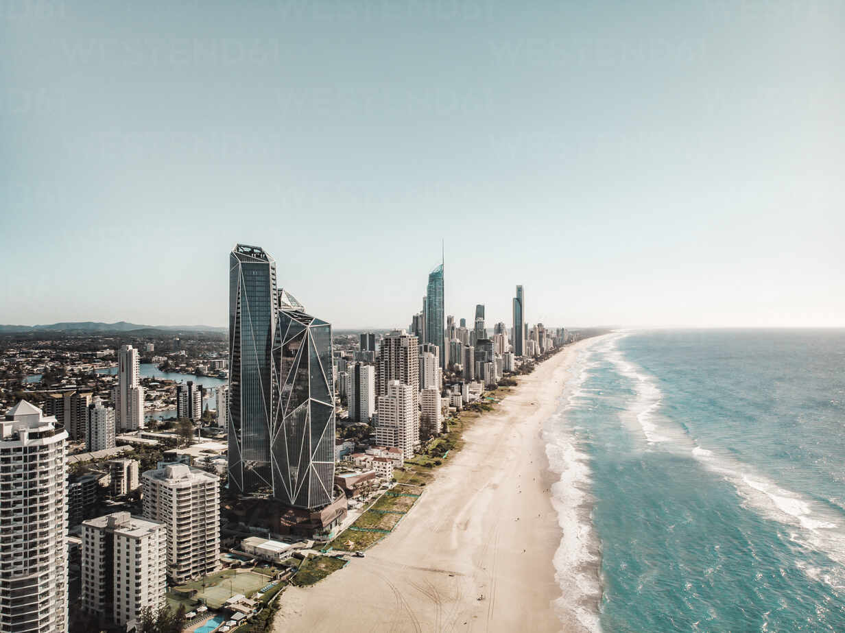 Premium stock video - Looking back at surfers paradise from water with drone