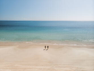 Aerial view of a couple walking on Rainbow Beach, Queensland, Australia. - AAEF10120