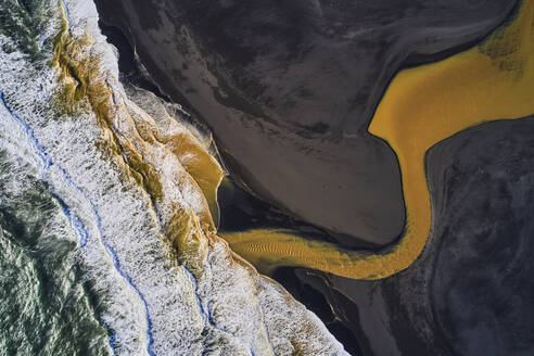 Aerial view of a colourful river estuary along the coastline facing the ocean, Rang√°rbing eystra, Southern, Iceland. - AAEF10359