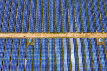 Aerial view of solar panels blue pattern along Karnaphuli river in Kaptai, Chittagong state, Bangladesh. - AAEF10640