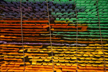 Aerial view of colourful cloth hanged at the thread in a public laundry in Narayanganj, Dhaka, Bangladesh. - AAEF10853