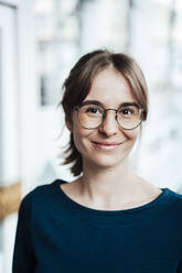 Smiling young woman with brown hair wearing eyeglasses - JOSEF05250