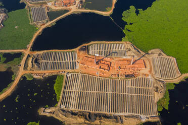 Aerial view of many brick factories with chimneys along Karnatali river, Savar, Dhaka province, Bangladesh. - AAEF10868