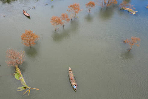 Luftaufnahme einer Person, die mit einem Kanu in der Landschaft von Keraniganj segelt, einem großen, durch Monsunregen überfluteten Gebiet in der Provinz Dhaka, Bangladesch. - AAEF11046