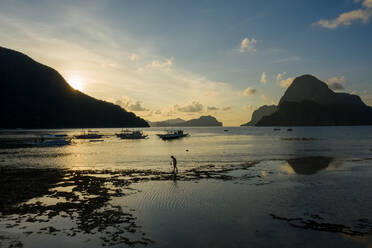 Aerial view of person walking on beach at sunet, El Nido, the Philippines. - AAEF11218