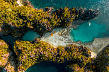 Aerial view of kayaks attached together in pattern in bay of El Nido, the Philippines. - AAEF11233