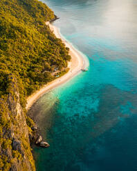 Aerial view of outrigger fishing boat on sandy beach, El Nido, the Philippines. - AAEF11255