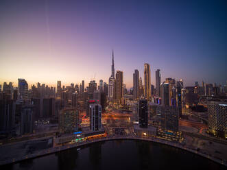 Aerial view of Dubai downtown with Burj Khalifa world's tallest skyscraper and city skyline in background at sunset, Dubai, United Arab Emirates. - AAEF11285