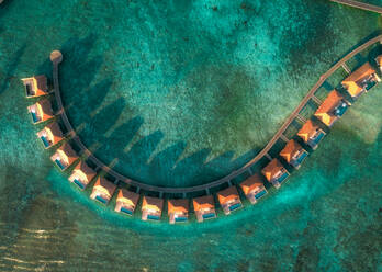 Aerial view of a beautiful luxury resort at sunset on Alifu Dhaalu Atoll in North Central Province in the middle of the Ocean, Alif ALif, Maldives. - AAEF11322