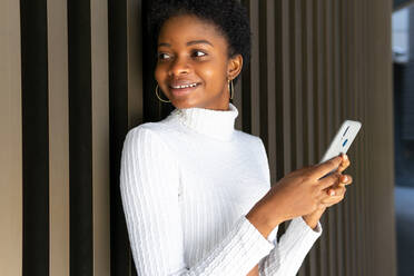 Cheerful black woman speaking on phone · Free Stock Photo