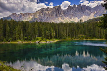 Latemar mountain range reflected in Lake Carezza (Karersee) in summer, South Tyrol, Dolomites, Italy, Europe - RHPLF20495