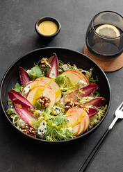 From above colorful delicious salad with endives, apple and roquefort cheese on dark background - ADSF28190