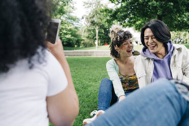 Happy male and female friends at public park - ASGF00866