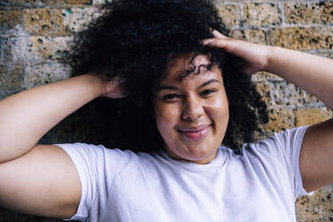 Young woman with hands in hair - ASGF00889