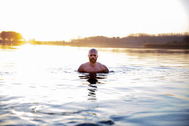 Mature man in water at morning - FVDF00395