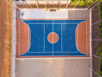 Luftaufnahme eines Basketball- und Multisportplatzes und einer Straße in einem Viertel in der Nähe von Aquiraz in Brasilien. - AAEF11440