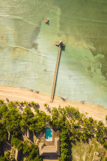 Luftaufnahme eines hölzernen Stegs im Meer in der Nähe eines Luxusresorts mit Swimmingpool im Bundesstaat Puerto Plata, Villa Isabela, Dominikanische Republik. - AAEF11542