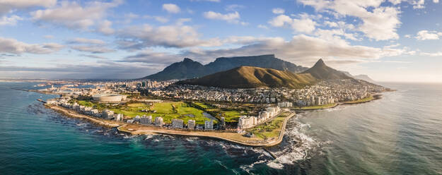 Panoramic aerial view of Lion‚Äôs Head, Green Point Stadium, Table Mountain and Mouille Point Lighthouse in summer from Atlantic Seaboard Sea Point Cape Town, South Africa - AAEF11700