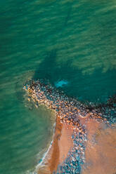 Aerial view of a Groyne, sea defence, at sunset, with shadows, Barton On Sea, New Milton, Hampshire, United Kingdom - AAEF11799