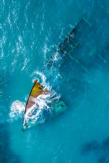 Aerial view of a sunken and abandoned ship near 