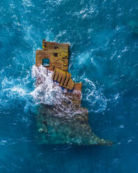 Aerial view of a part of a sunken and abandoned ship near 