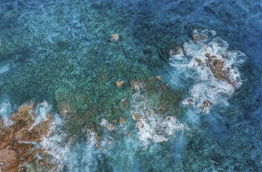 Aerial view of waves crashing over granite boulders, Seychelles. - AAEF11958