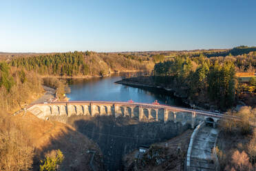 Aerial view of Barrage de Robertville, a dam stopping the water of Robertville lake in Waimes, Li√®ge, Belgium. - AAEF12269